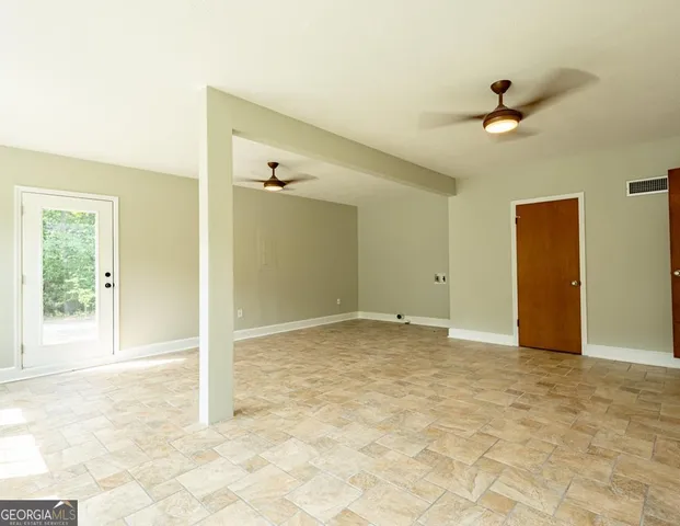 a view of an empty room with a window
