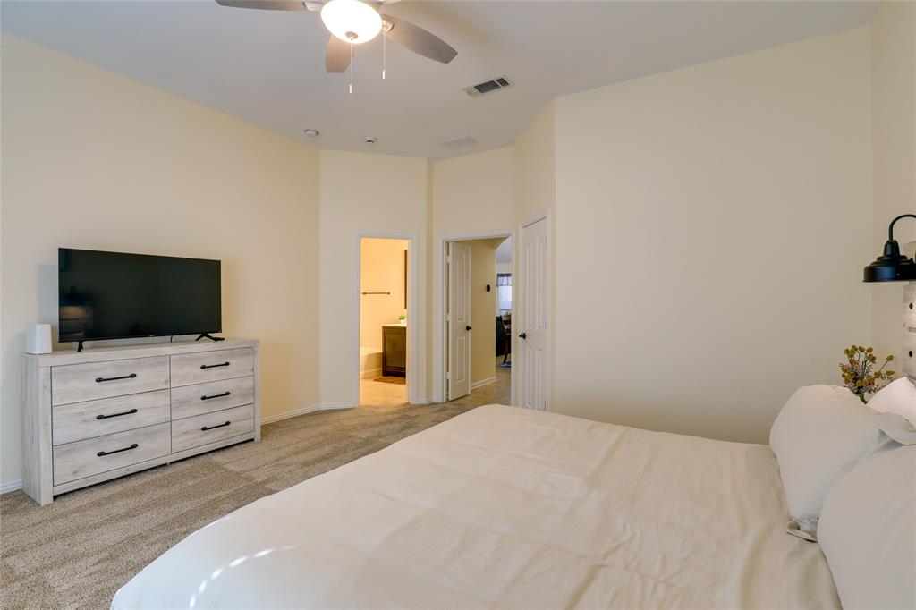 4502 Ridgeway Drive Mansfield, TX 76063 - Photo 11 of 29 a bedroom with a bed and flat screen tv