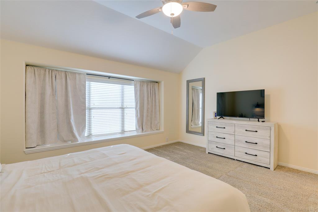 4502 Ridgeway Drive Mansfield, TX 76063 - Photo 12 of 29 a bedroom with a bed and flat screen tv