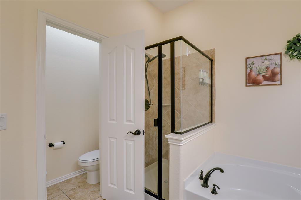 4502 Ridgeway Drive Mansfield, TX 76063 - Photo 14 of 29 a bathroom with a toilet and a shower