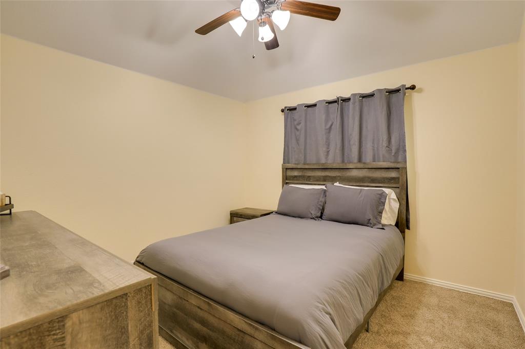 4502 Ridgeway Drive Mansfield, TX 76063 - Photo 15 of 29 a bedroom with a bed and cabinets