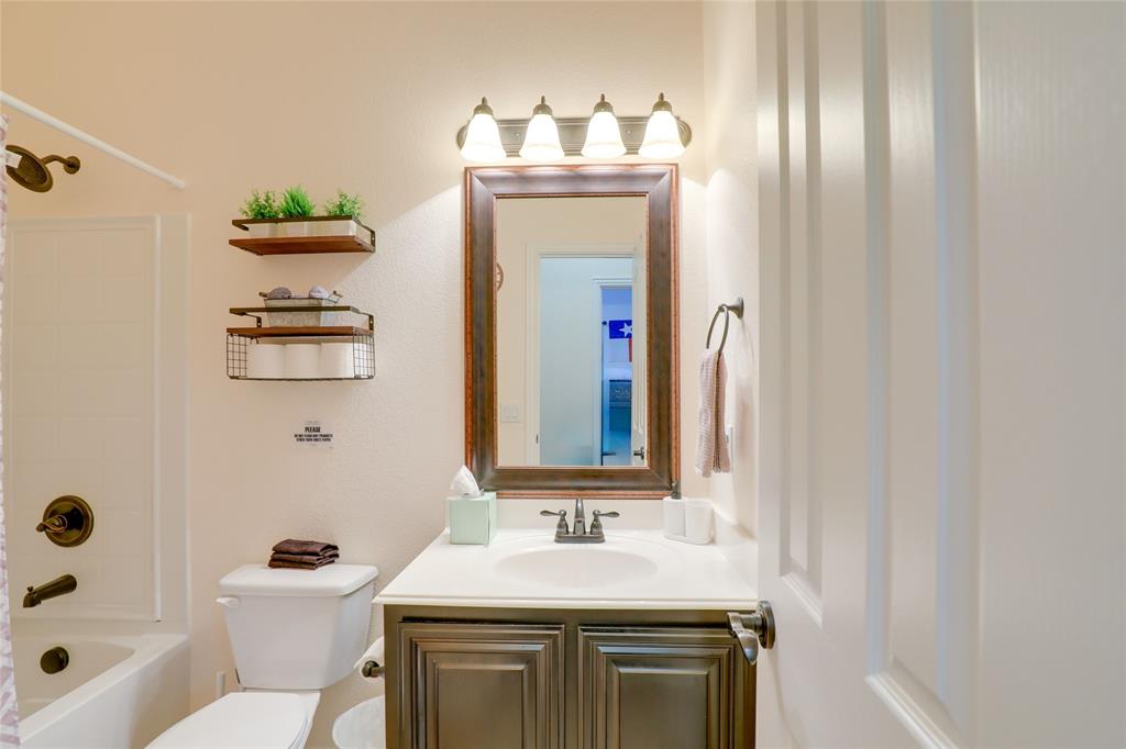 4502 Ridgeway Drive Mansfield, TX 76063 - Photo 17 of 29 a bathroom with a sink a toilet and a mirror