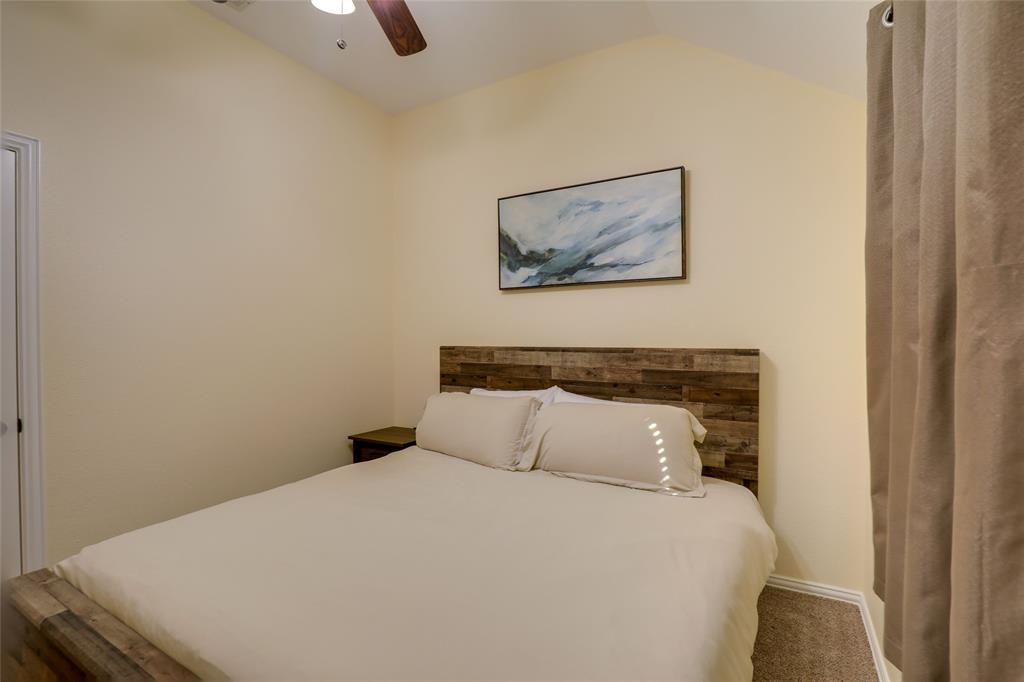 4502 Ridgeway Drive Mansfield, TX 76063 - Photo 19 of 29 a bedroom with a bed and a painting on the wall