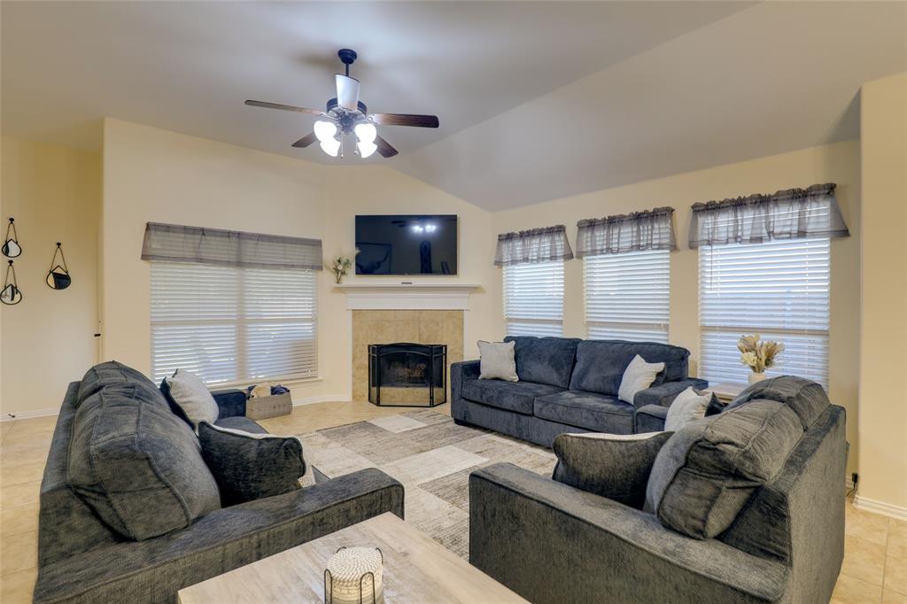 4502 Ridgeway Drive Mansfield, TX 76063 - Photo 4 of 29 a living room with furniture a flat screen tv and a fireplace