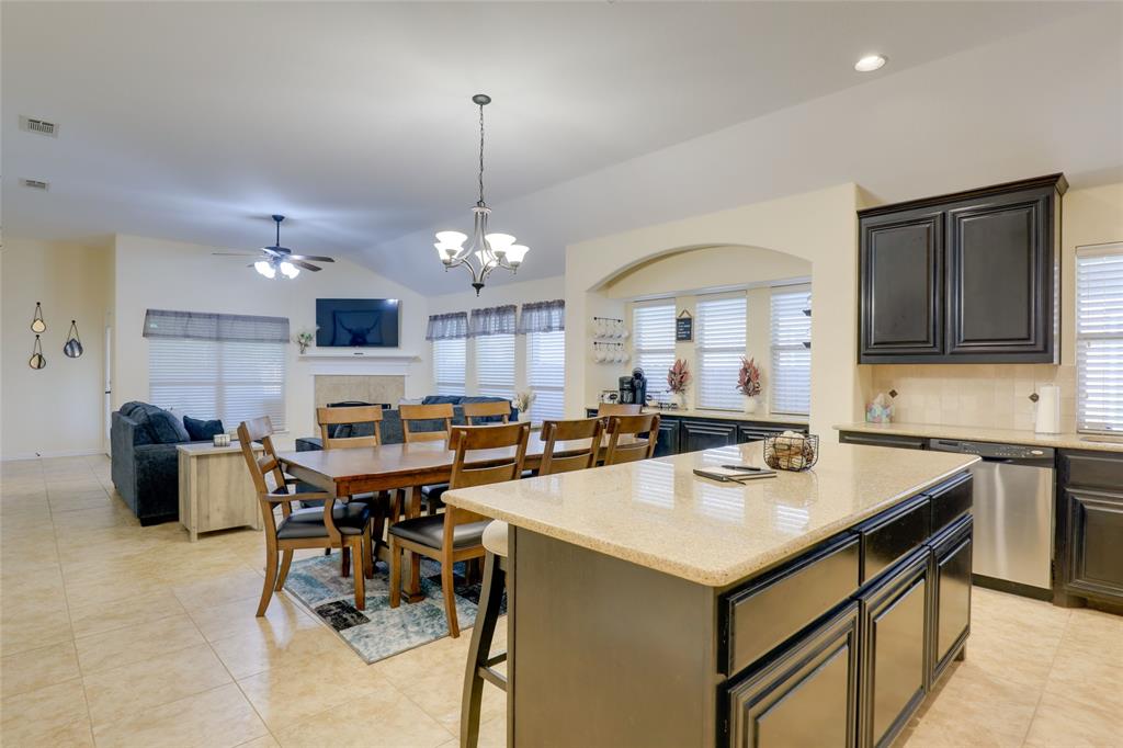 4502 Ridgeway Drive Mansfield, TX 76063 - Photo 9 of 29 a kitchen with a stove a refrigerator and a dining table