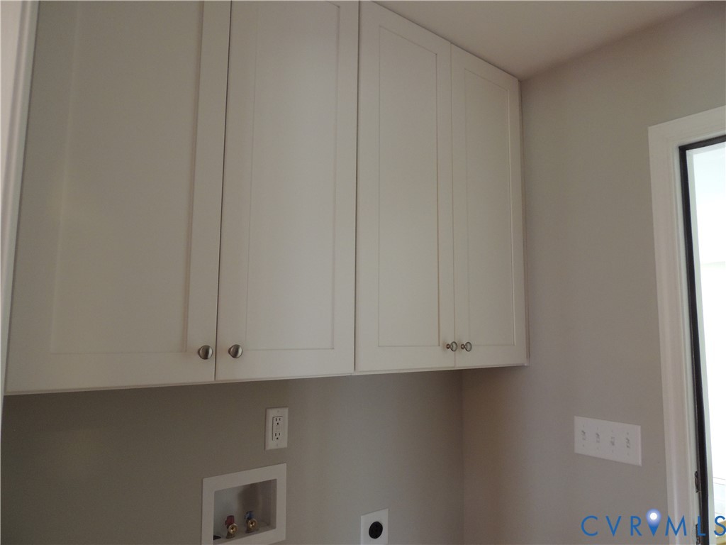 4417 Olgers Road Sutherland, VA 23885 - Photo 22 of 24 Upper cabinetry with white shaker-style doors and