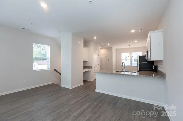 a view of kitchen with stainless steel appliances refrigerator microwave and stove