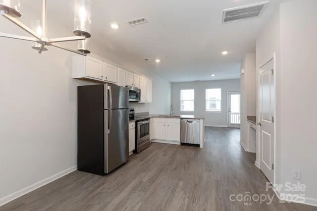 a kitchen with stainless steel appliances a refrigerator and a stove