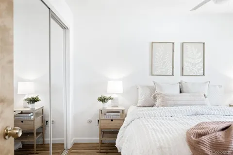 a bedroom with a bed and a potted plant