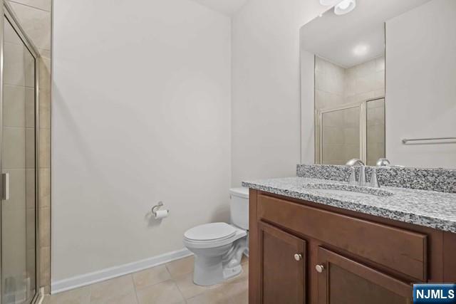 54 Arnold Drive Wood-Ridge, NJ 07075 - Photo 17 of 40 a bathroom with a granite countertop sink a toilet and a mirror