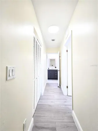 a view of a hallway with wooden floor