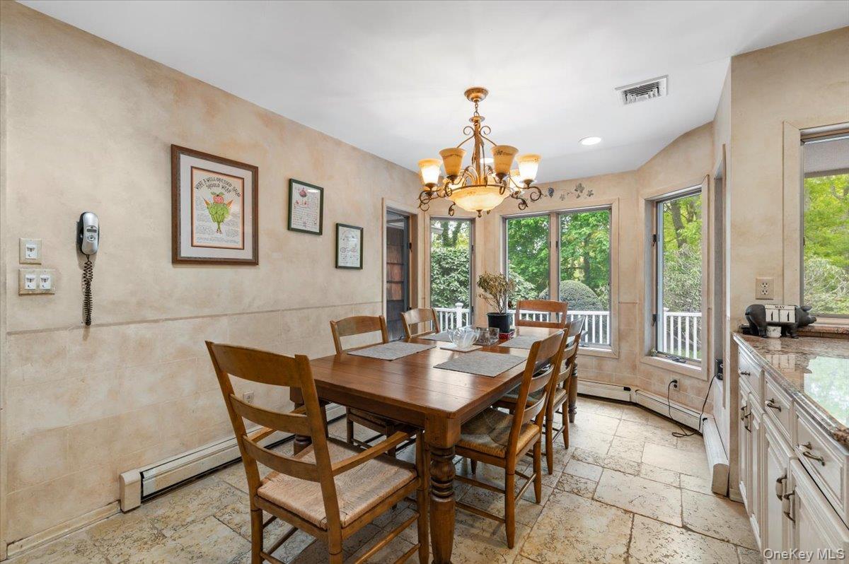 6 Apex Road Melville, NY 11747 - Photo 17 of 50 a view of a dining room with furniture large windows and wooden floor
