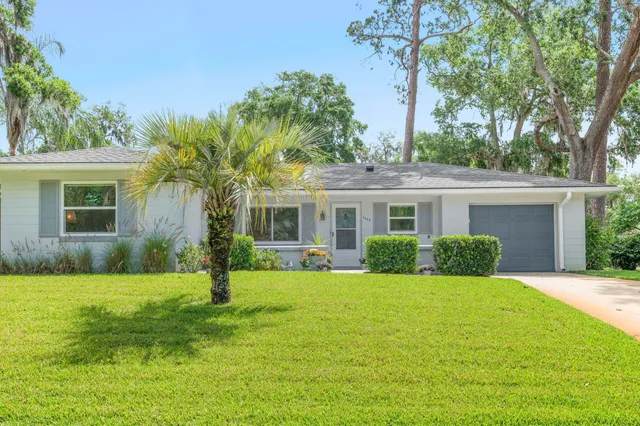 a front view of house with yard and green space