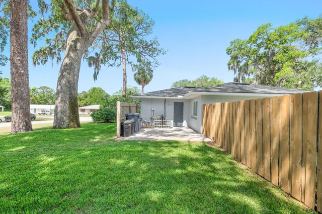 a view of a house with backyard and sitting area