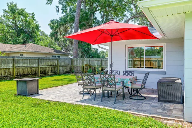 a view of a chair and table in the garden