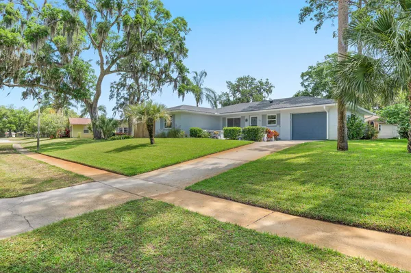 a view of a house with a backyard
