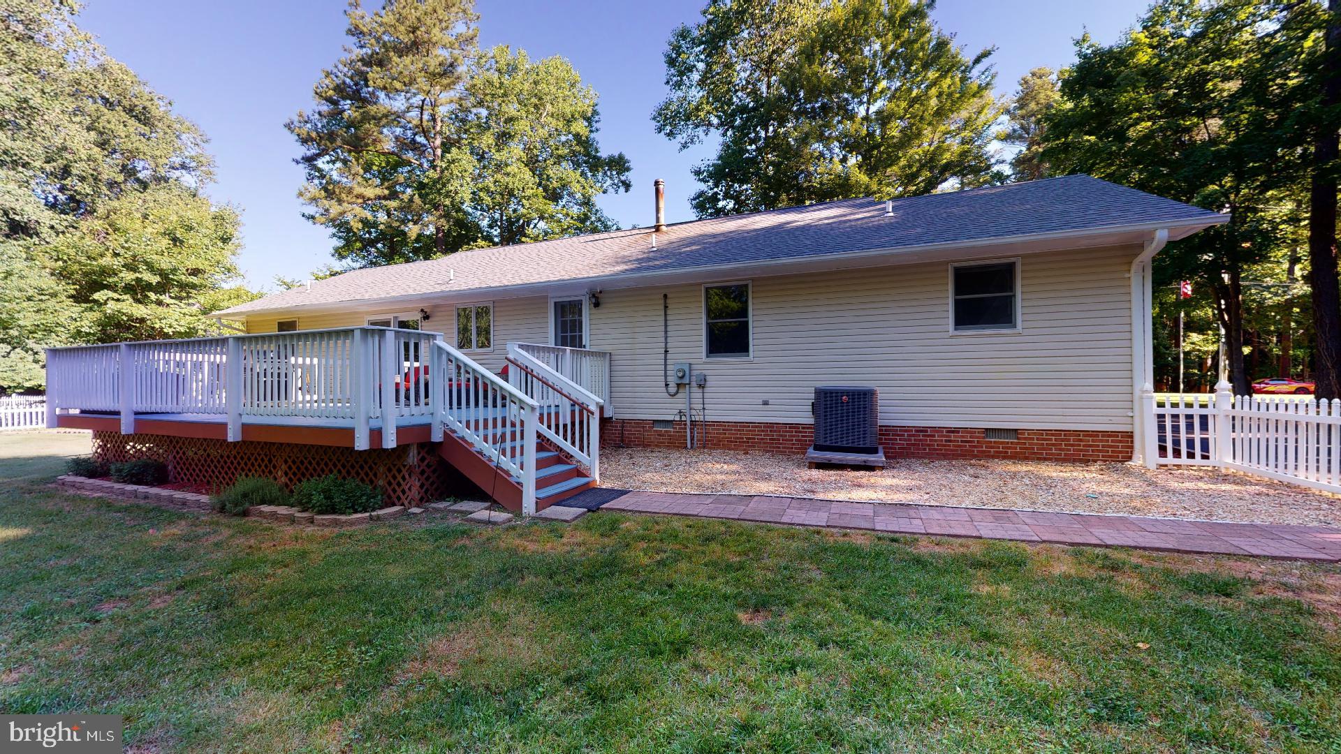 1055 Redeye Road Lusby, MD 20657 - Photo 35 of 38 Deck Leads to Level Rear Yard