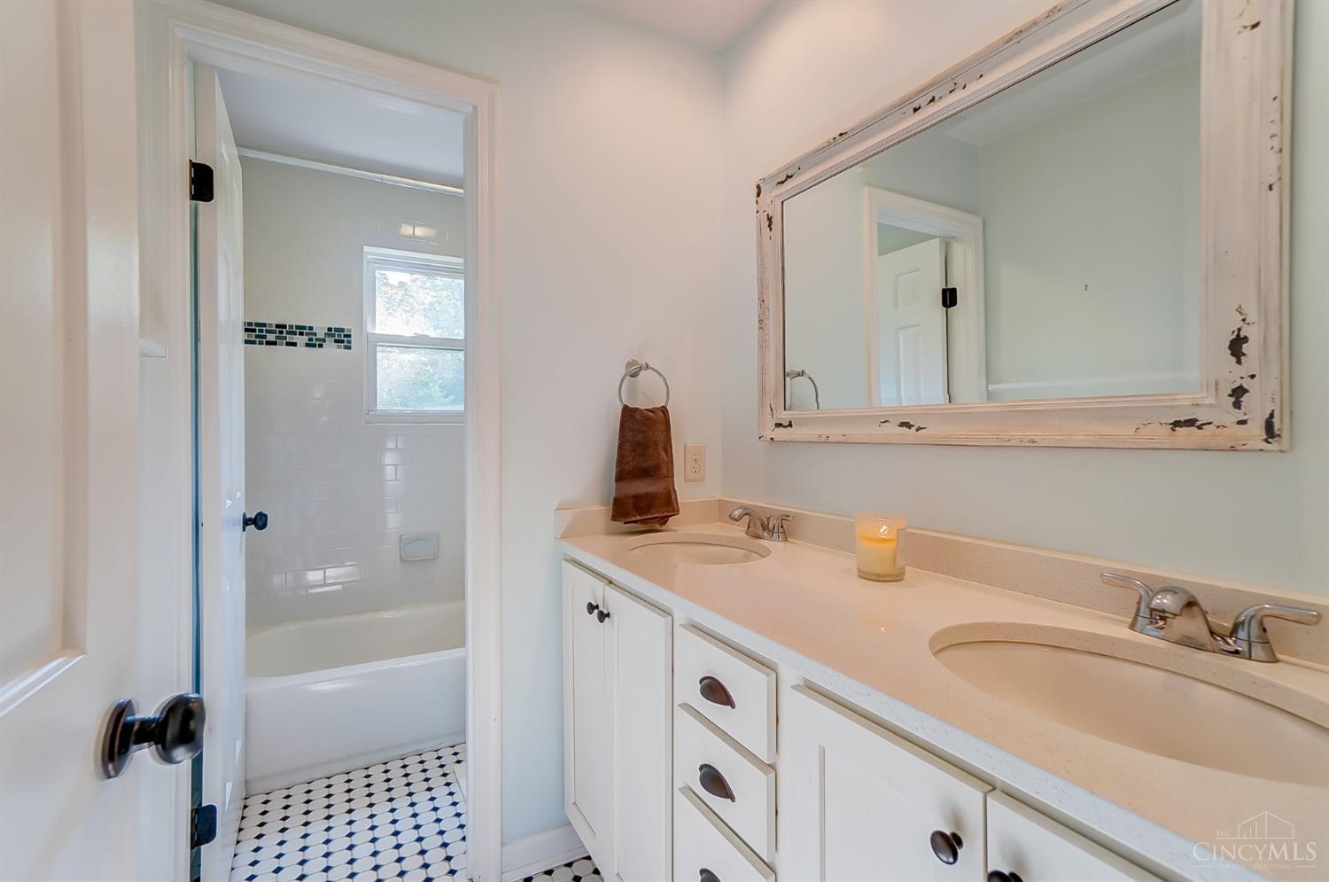 7272 Ayers Road Cincinnati, OH 45255 - Photo 33 of 54 Upstairs hallway bathroom is shared by the 3 bedrooms. Updated quartz countertops, tile floor with a separate water closet and tub/shower combo.