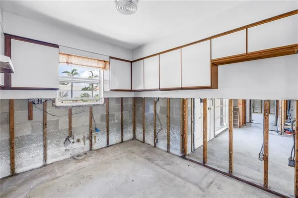 an empty room with furniture and a large window