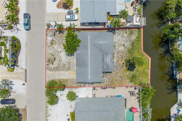 aerial view of a house with a yard and sitting area