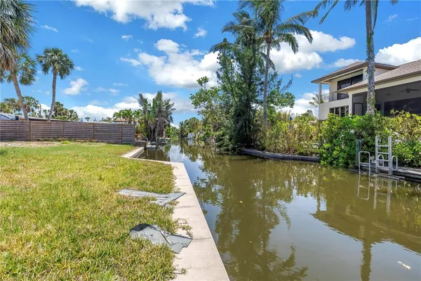 a view of a house with swimming pool and next to a yard