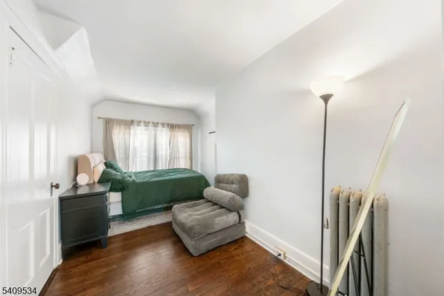 a living room with furniture window and a wooden floor