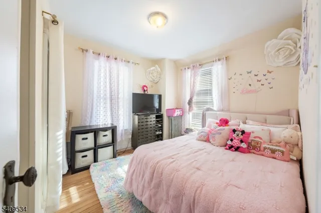 a bedroom with a bed and a flat tv screen