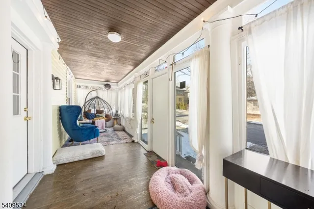 a hallway with wooden floor and furniture