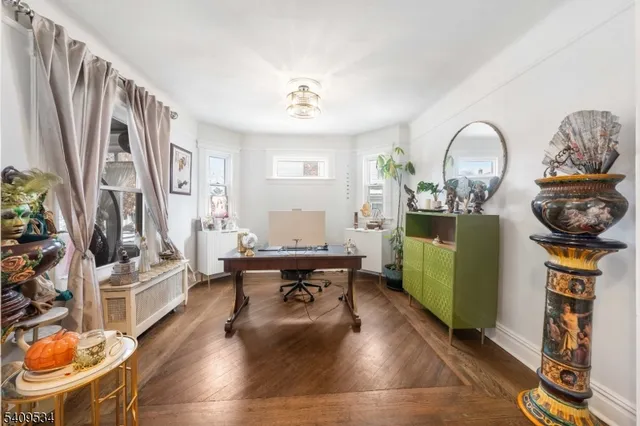 a living room with fireplace furniture and a wooden floor