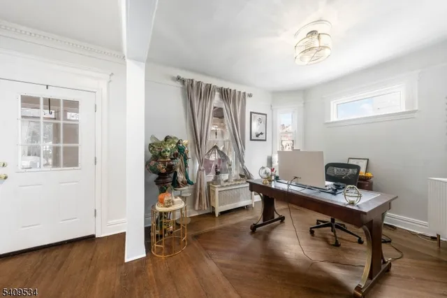 a view of a workspace with furniture and a window