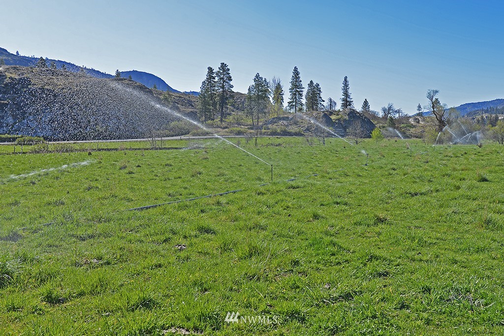 322 North End Omak Lake Road Omak, WA 98841 - Photo 15 of 40 a view of a house with a yard and a fountain