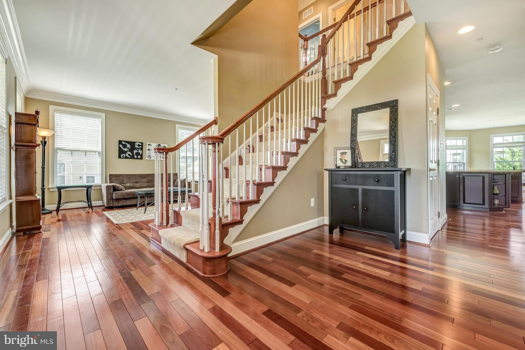 Custom cherry hardwood greets you at the foyer