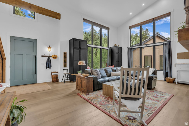 1766 West Tollgate Cyn Road Coalville, UT 84017 - Photo 5 of 59 Open-concept living space featuring high ceilings, light wood-finish flooring, and expansive windows