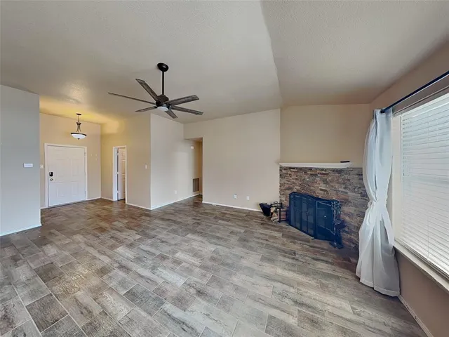 a view of empty room with a fireplace
