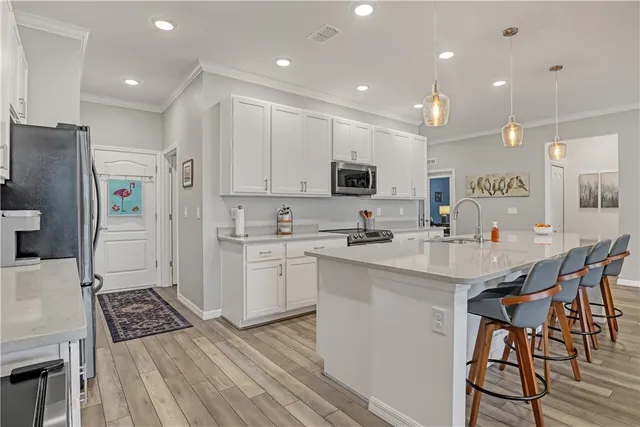 a kitchen with stainless steel appliances kitchen island granite countertop a sink and cabinets