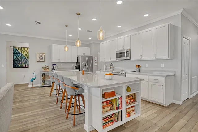 a kitchen with stainless steel appliances a refrigerator sink and cabinets