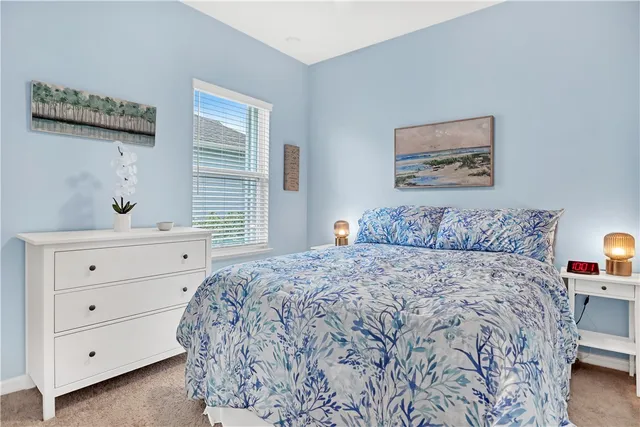 a view of an empty room with wooden floor and windows