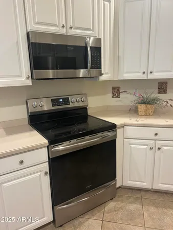 a metallic refrigerator freezer sitting in a kitchen