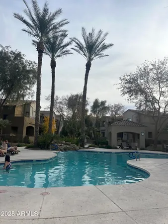 a view of a house with a yard and a fountain