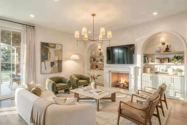 a living room with fireplace furniture and a fireplace