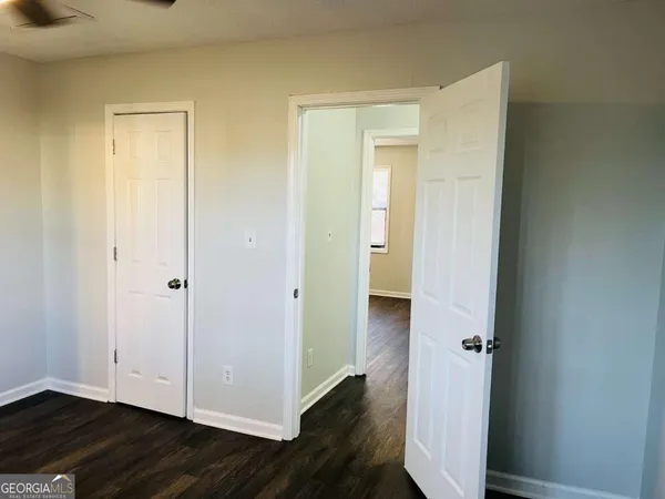 a view of a hallway with wooden floor