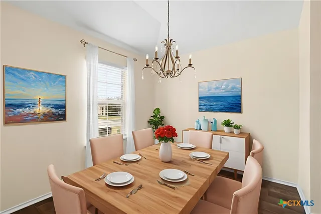 a view of a dining room with furniture a chandelier and wooden floor