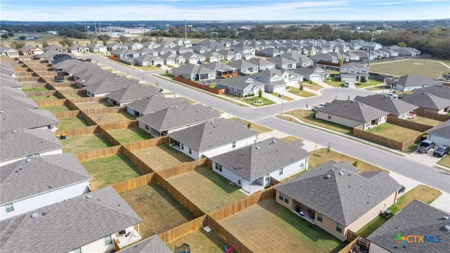 an aerial view of residential houses with outdoor space