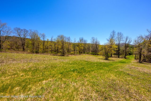 a view of yard with swimming pool and trees