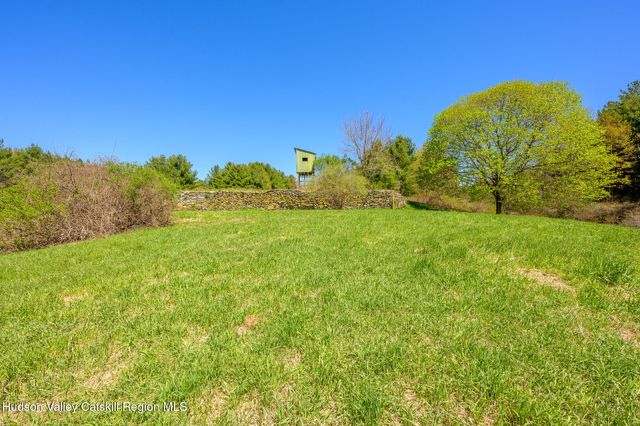 a view of a green yard with a house in the background
