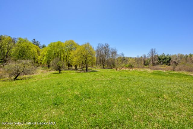 a view of grassy field with trees