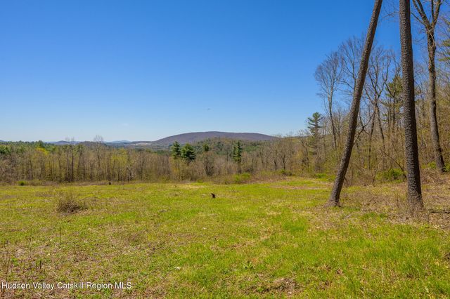 a view of an ocean beach and mountain
