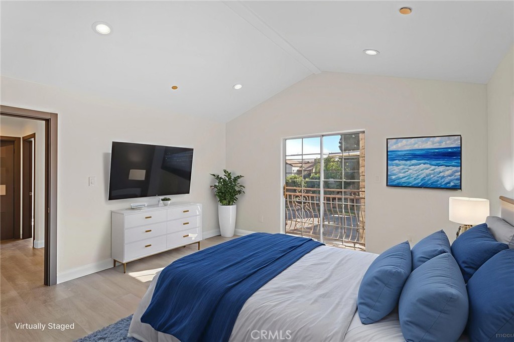 14957 Victory Boulevard, Unit 101 Van Nuys, CA 91411 - Photo 9 of 26 a bedroom with a bed and a flat screen tv