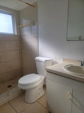 a white toilet sitting next to a bathroom sink