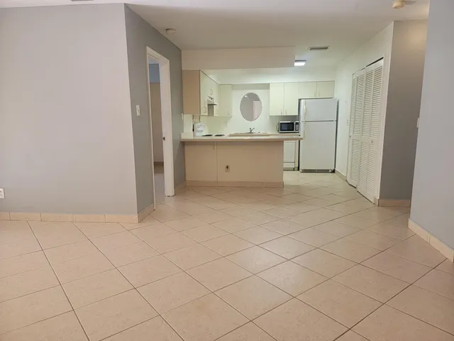 a view of kitchen with granite countertop cabinets